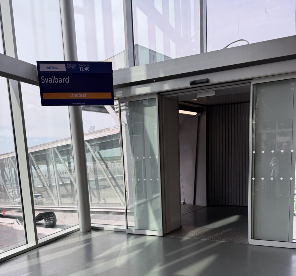 Departure gate sign at Helsinki Airport showing a charter flight to Svalbard