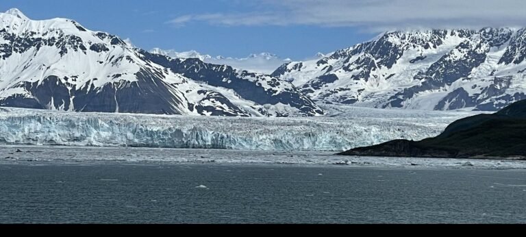 Hubbard Glacier's ice face rising above the water in Alaska